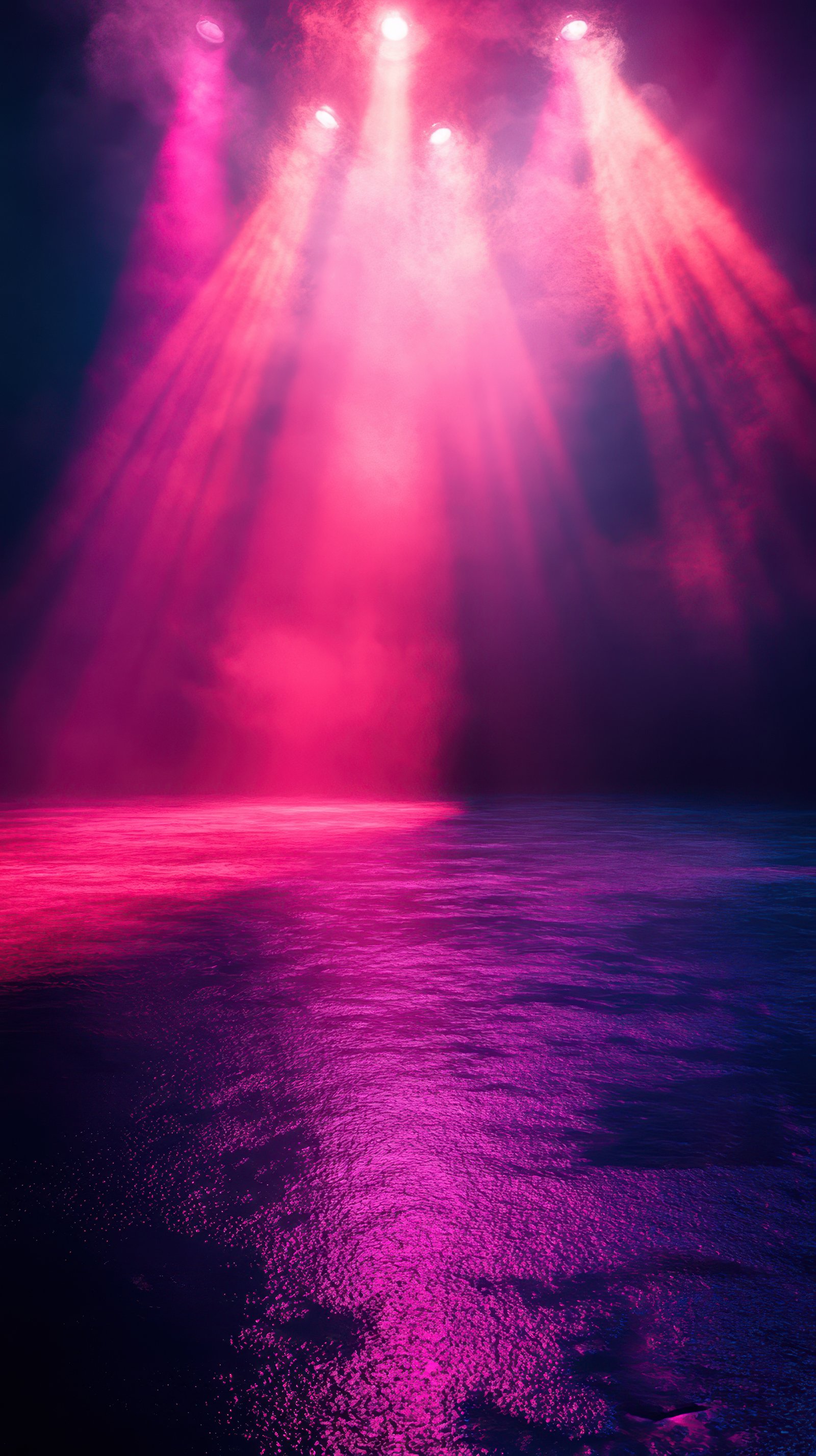 Colorful stage lights illuminating a reflective surface during an evening performance